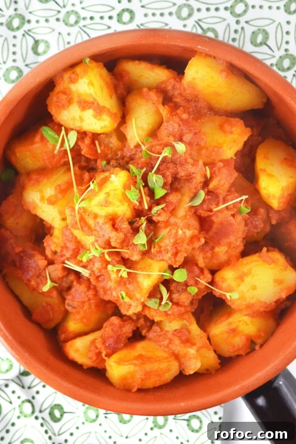 Patate Rifatte (redone potatoes) are a great potato side dish made from leftover boiled potatoes, fried with garlic and herbs and cooked in a delicious tomato sauce. www.insidetherustickitchen.com Patate Rifatte - an Italian potato side dish www.insidetherustickitchen.com
