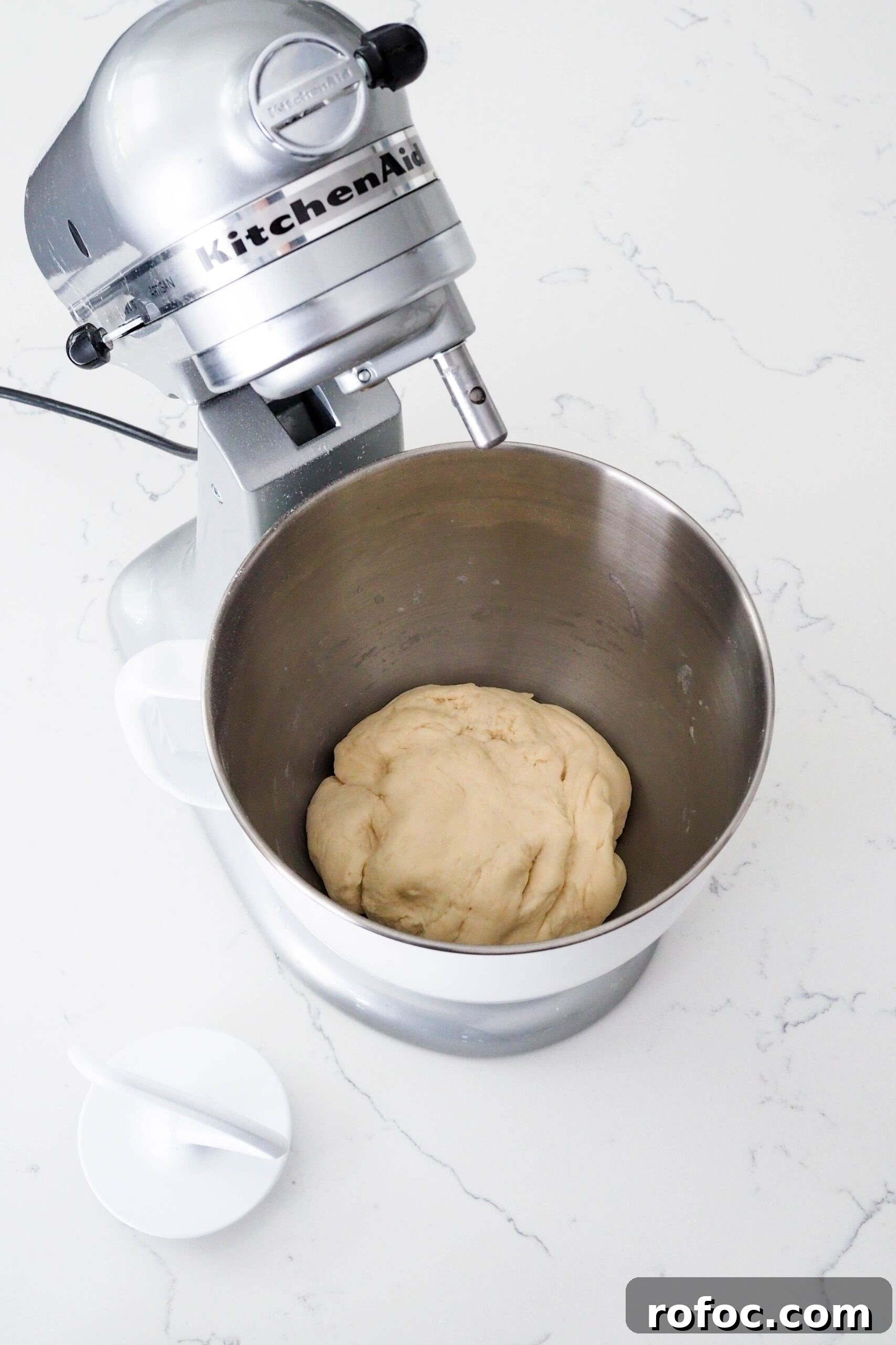 Crispy Garlic Breadsticks Recipe with Herb Butter Dip 6 Freshly kneaded enriched dough in a mixer bowl.
