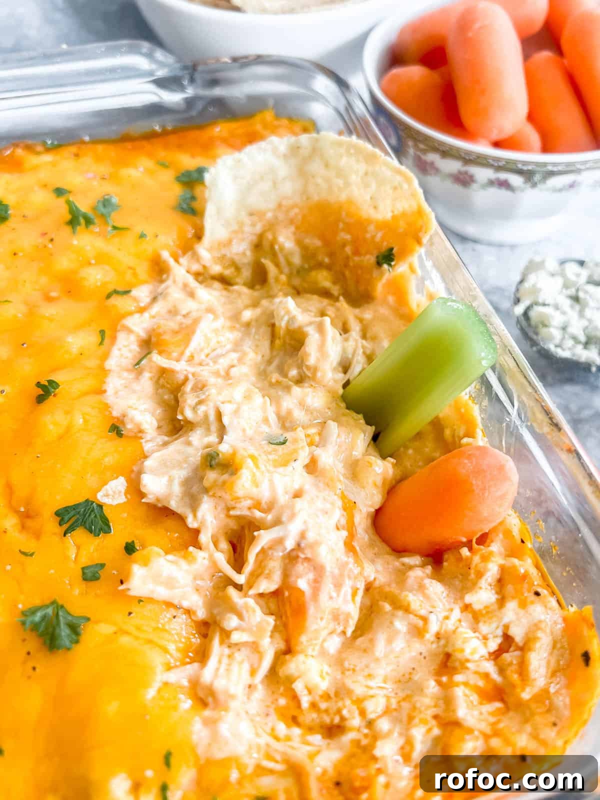 Creamy Buffalo Chicken Dip Made with Canned Chicken 2 Buffalo chicken dip with canned chicken recipe with carrots and celery in the dip.