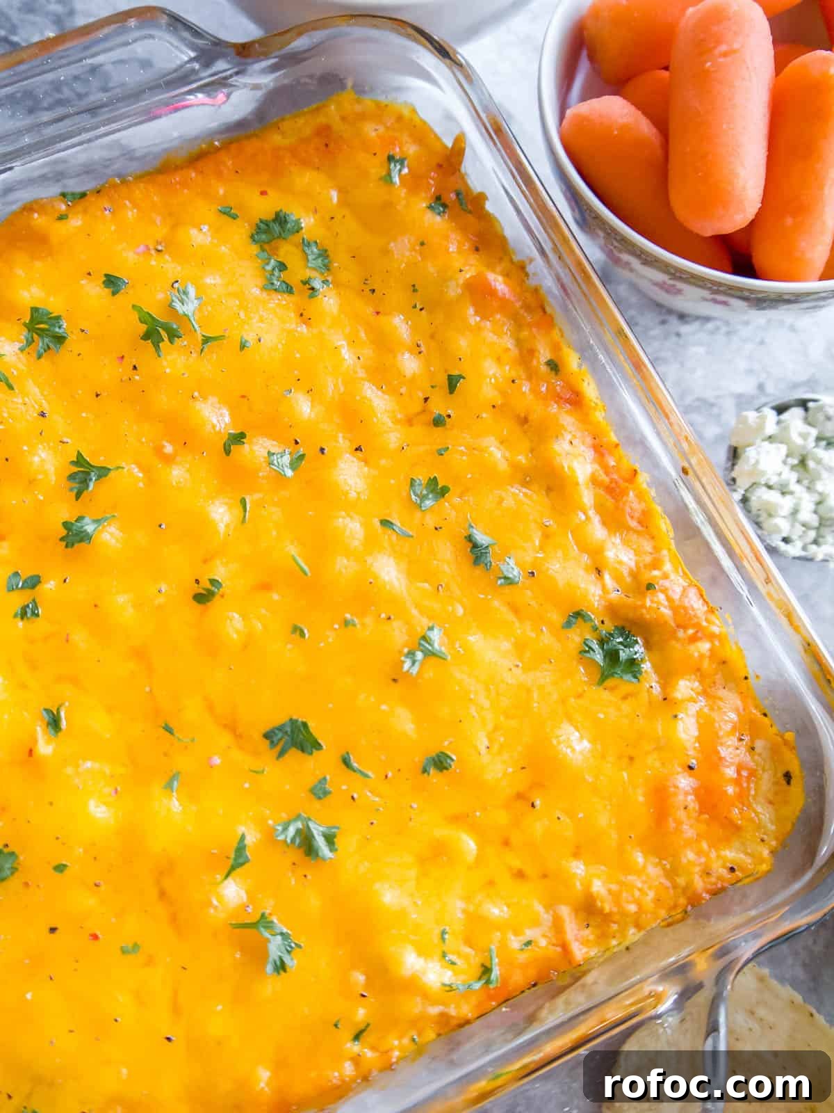Creamy Buffalo Chicken Dip Made with Canned Chicken 3 Frank's redhot buffalo chicken dip covered in cheese.