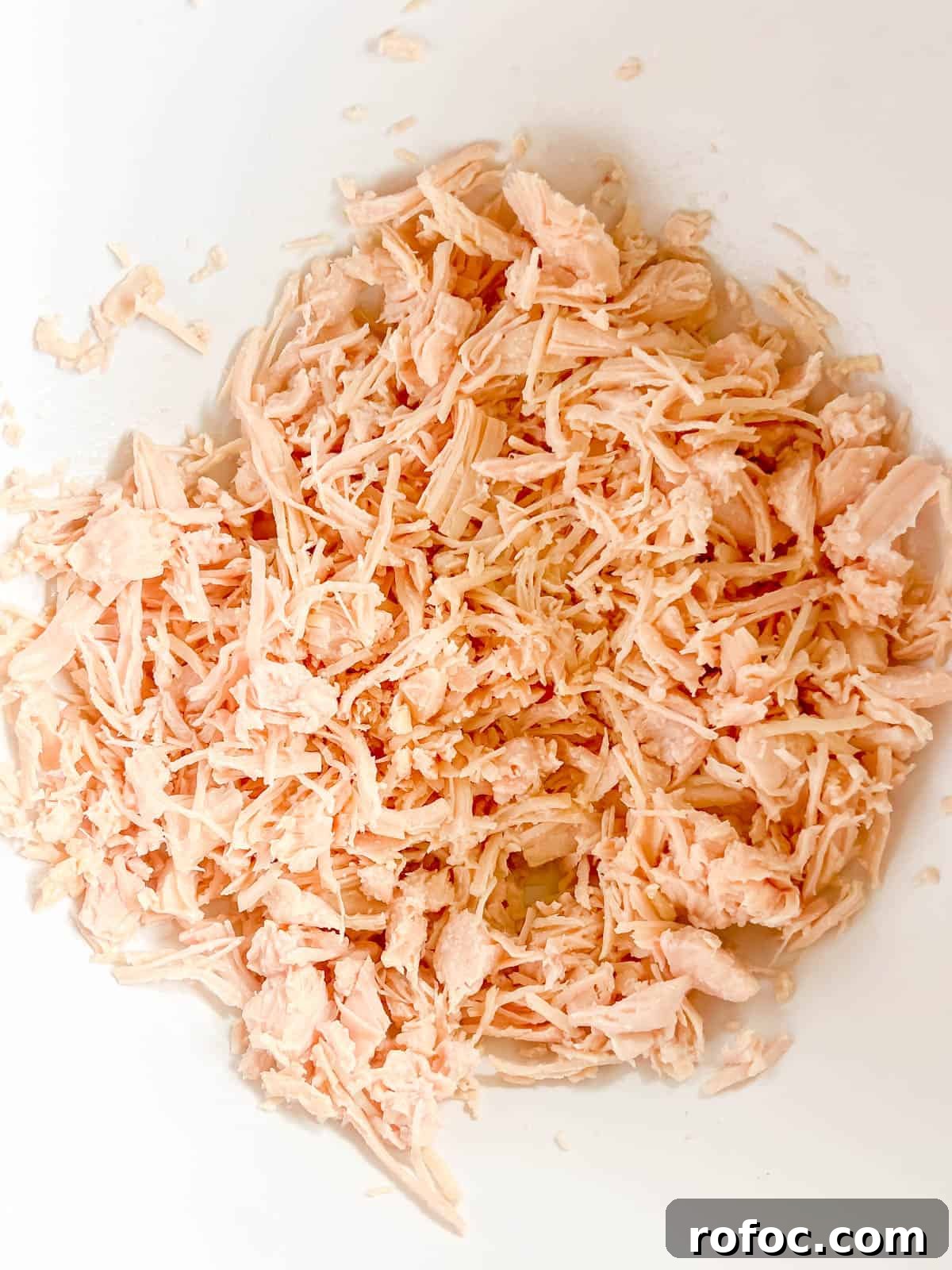 Creamy Buffalo Chicken Dip Made with Canned Chicken 5 Canned chicken in a bowl.