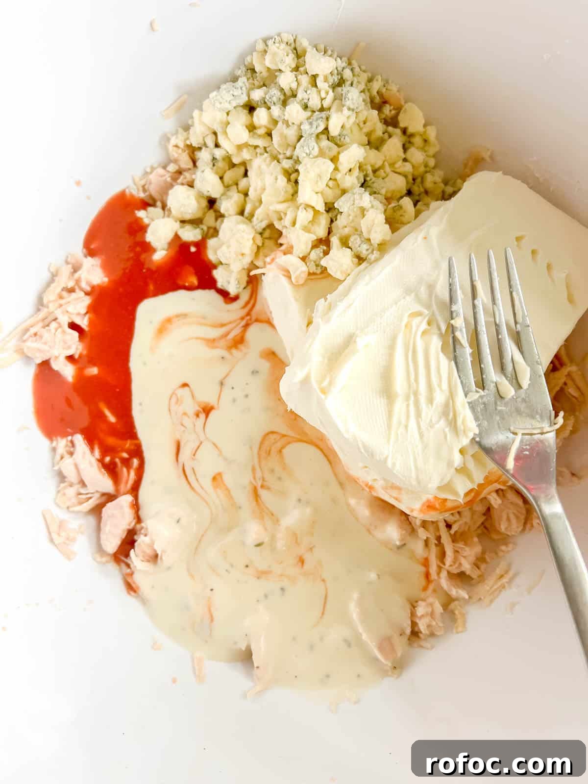 Creamy Buffalo Chicken Dip Made with Canned Chicken 6 All the other buffalo chicken ingredients added to the bowl.