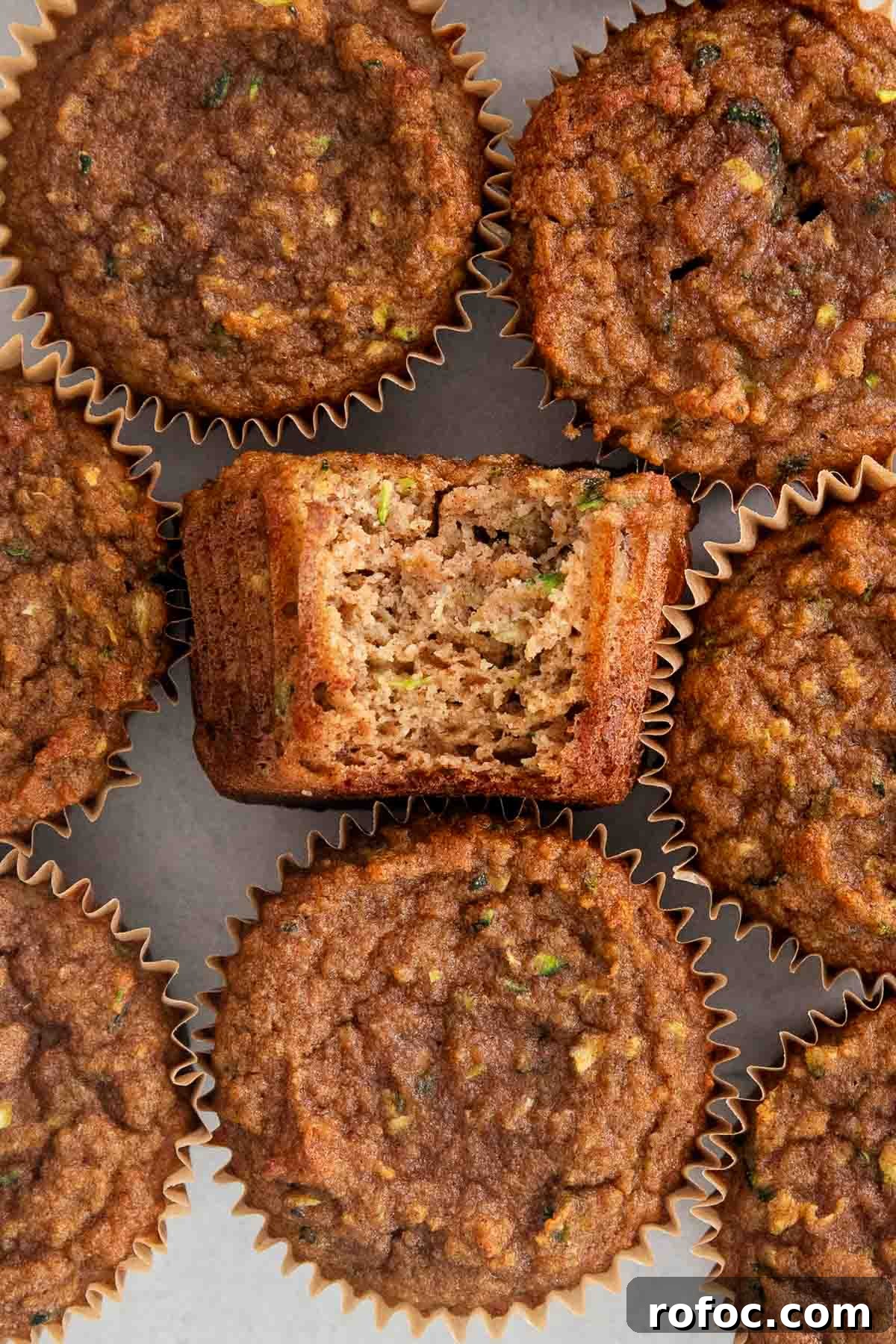 Gluten-Free Paleo Zucchini Muffins with Almond Flour 7 aerial view of paleo zucchini muffins with one muffin missing a bite