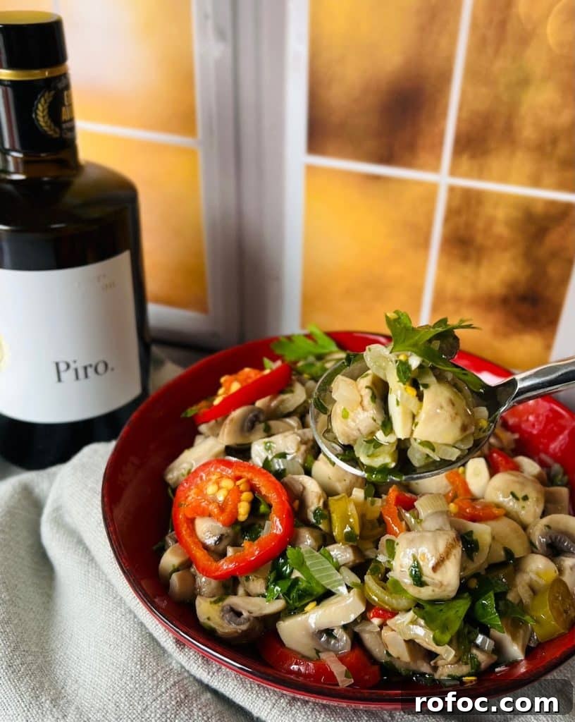 Spicy Marinated Italian Deli Mushrooms — Pickled Mushroom Recipe 20 Spicy Italian Marinated Mushrooms Finished and Styled with Spoon and Bottle