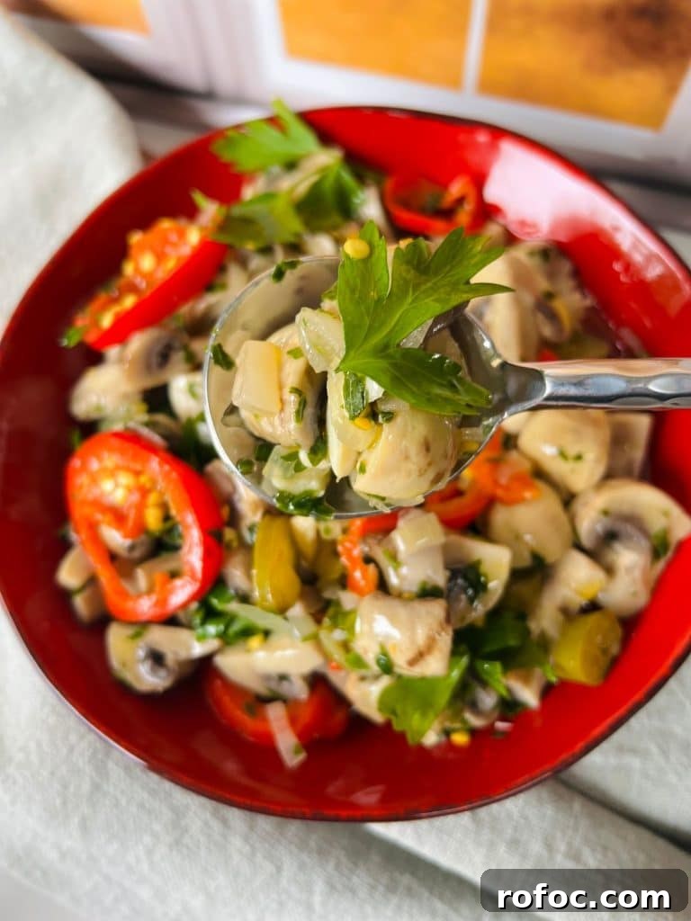 Spicy Marinated Italian Deli Mushrooms — Pickled Mushroom Recipe 23 Spicy Italian Pickled Mushrooms Finished and Styled with Spoon.