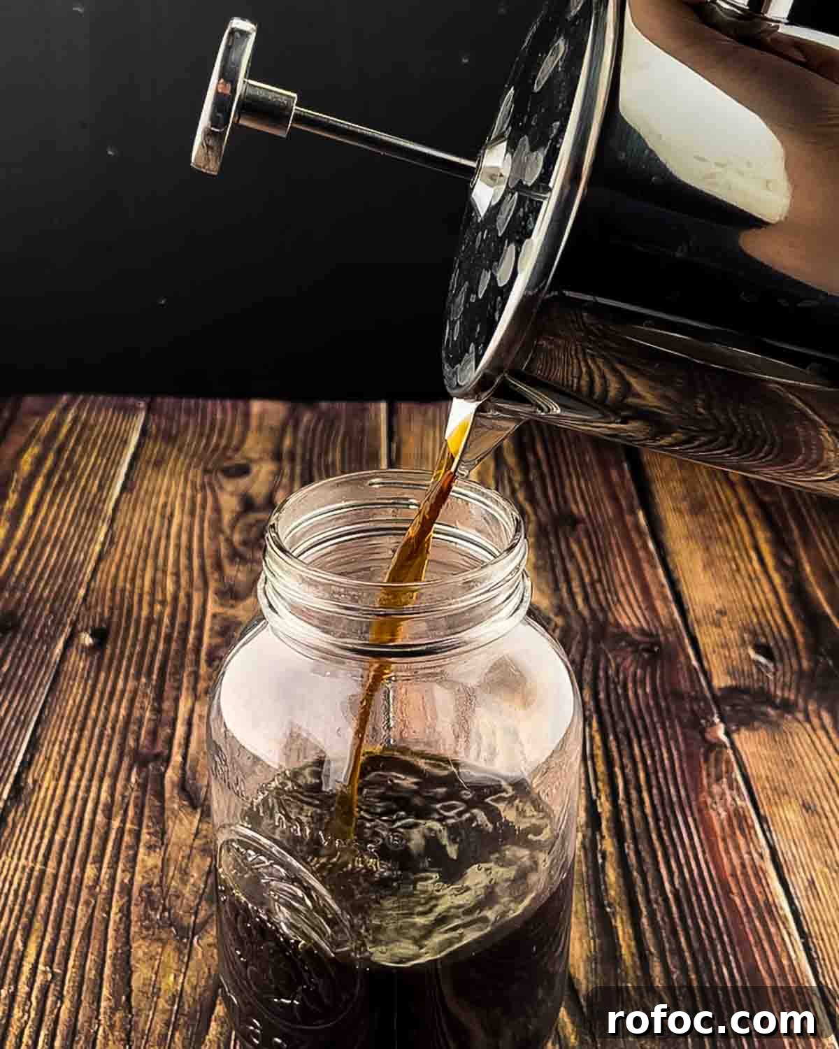 Homemade Vanilla Sweet Cream Cold Brew Recipe You’ll Love 5 The cold brew concentrate being poured into a mason jar from the coffee pot.