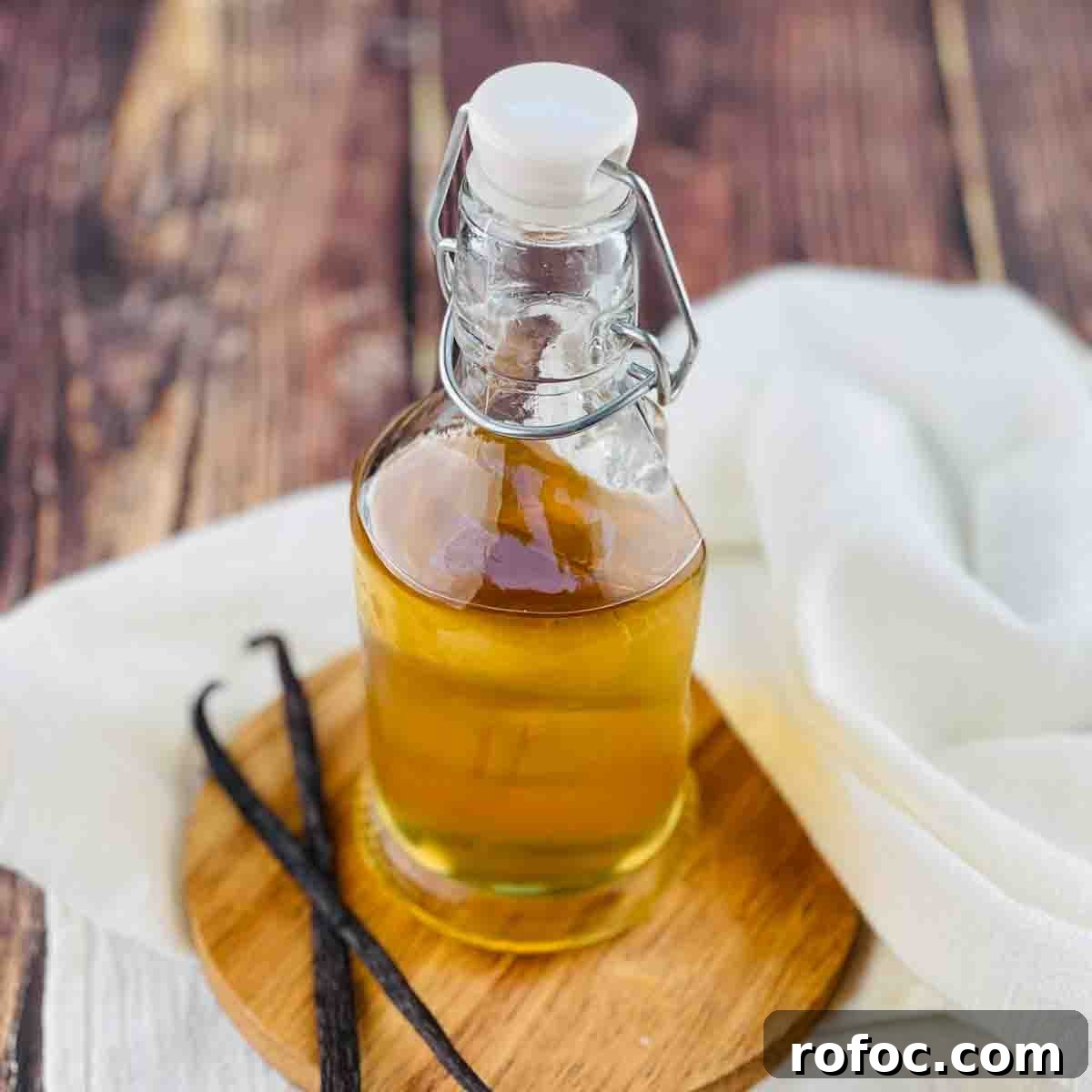 Homemade Vanilla Sweet Cream Cold Brew Recipe You’ll Love 7 Vanilla simple syrup in a glass jar with vanilla beans beside it.