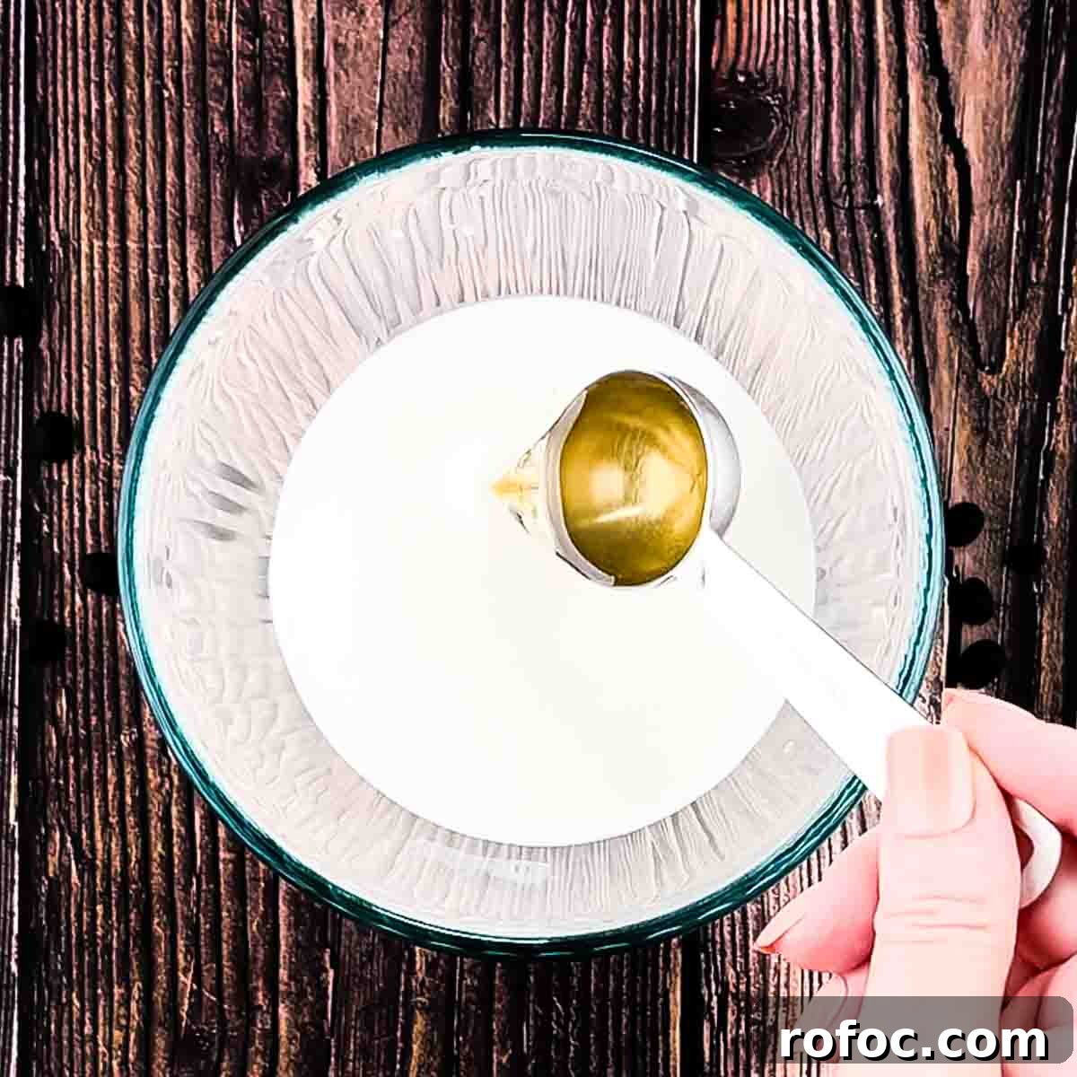 Homemade Vanilla Sweet Cream Cold Brew Recipe You’ll Love 8 Vanilla simple syrup being added to a small glass bowl with the heavy cream and milk.