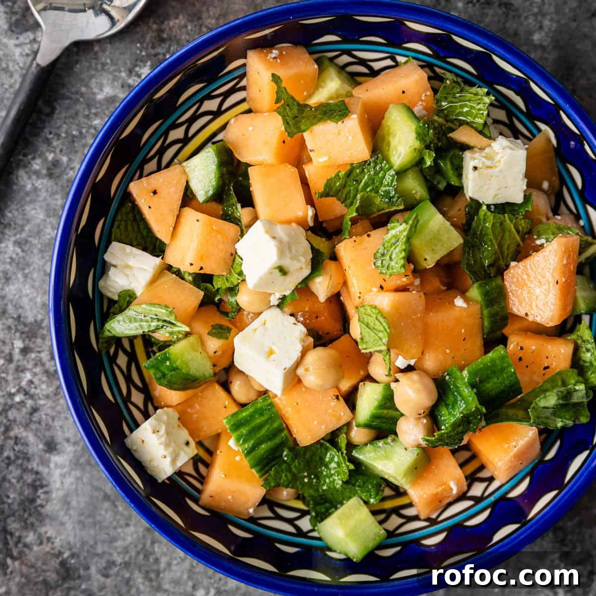 overhead: a large blue and white bowl full of fresh melon salad