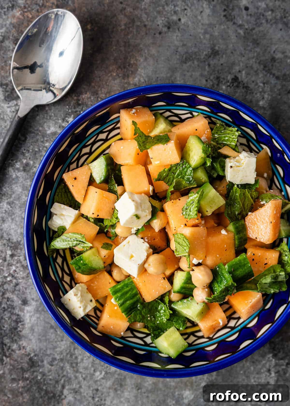 overhead: a serving of my melon salad recipe in a blue and white bowl
