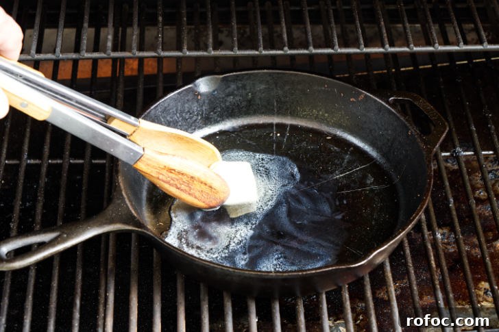 Traeger Smores Dip Recipe for Campfire-Style Desserts 5 Melting butter in a skillet on the grill.
