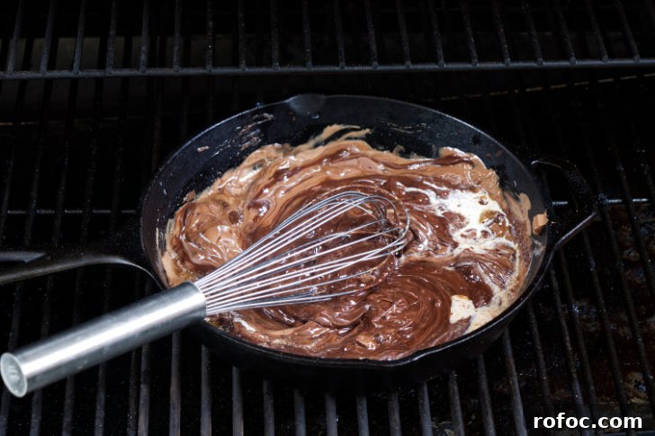 Traeger Smores Dip Recipe for Campfire-Style Desserts 7 Stirring cream into melted chocolate.