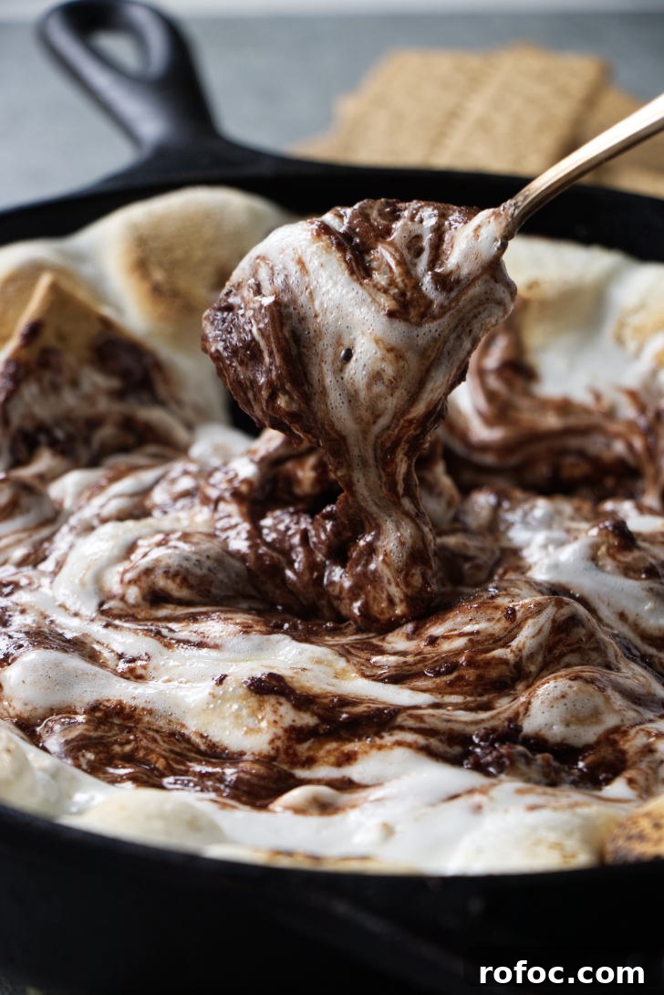 Traeger Smores Dip Recipe for Campfire-Style Desserts 10 Stirring chocolate and marshmallows together.