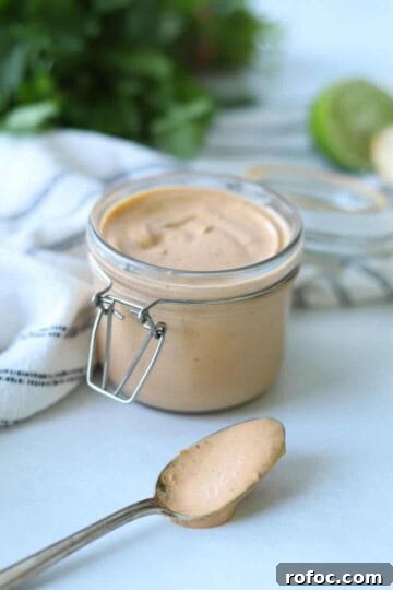 chipotle mayo in glass container with spoonful sitting in front