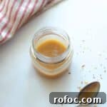 jar full of spicy honey mustard with spoon on the side