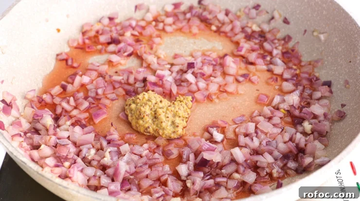 Warm German-Style Potato Salad Recipe for Authentic Flavor 4 adding dijon mustard to skillet