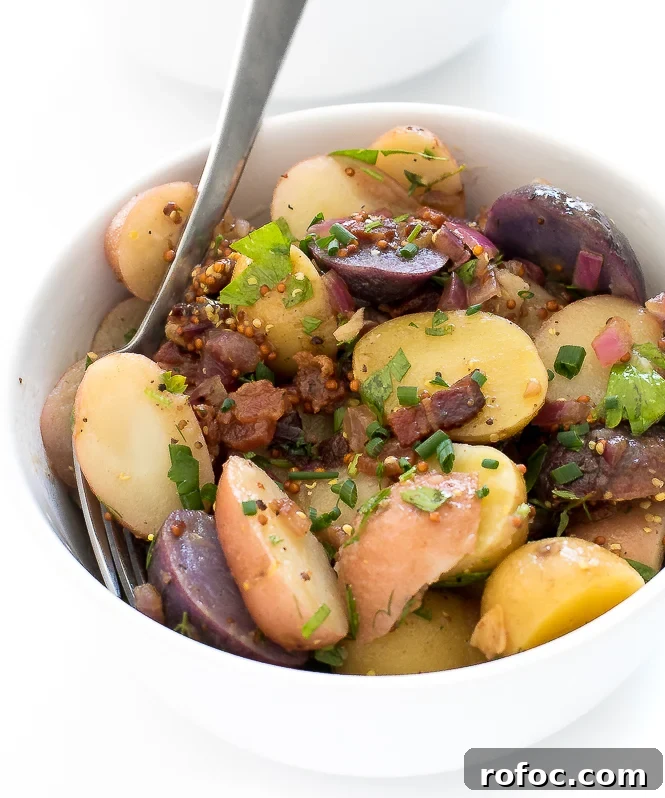 German Potato Salad Recipe | chefsavvy.com German Potato Salad Recipe in small white bowl with fork
