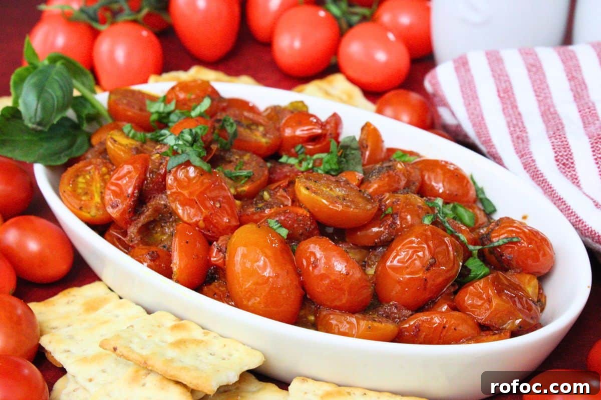 11 Creative Air Fryer Tomato Recipes for Flavorful Meals 4 serving dish filled with roasted air fryer cherry tomatoes topped with fresh basil