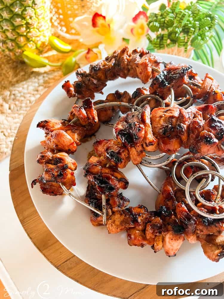 9 Tropical Cocktail Appetizers for Your Next Party 8 Plate with huli huli chicken kebabs on circular skewers for a tropical cocktail party.