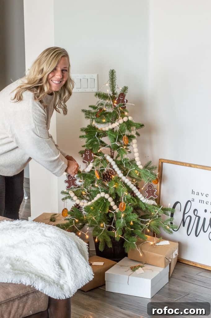 How to Create a Cozy Hygge Christmas Atmosphere 13 Girl decorating a modern Hygge Christmas tree