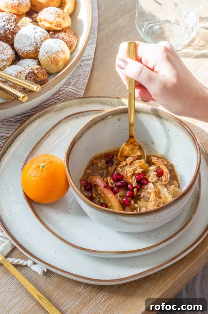 How to Create a Cozy Hygge Christmas Atmosphere 7 Bowl filled with instant pot apple crisp and pomegranates with an orange on the side