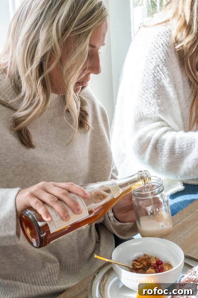 How to Create a Cozy Hygge Christmas Atmosphere 8 Lady pouring apple cider at Hygge Christmas breakfast