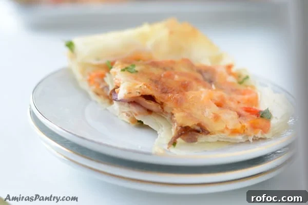 Game-Day Shrimp Phyllo Pizza Bites: Crispy Appetizer Recipe 3 A close up of a slice of pizza on a plate