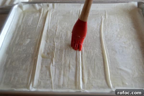 Game-Day Shrimp Phyllo Pizza Bites: Crispy Appetizer Recipe 5 A photo showing sheets of pastry and brush
