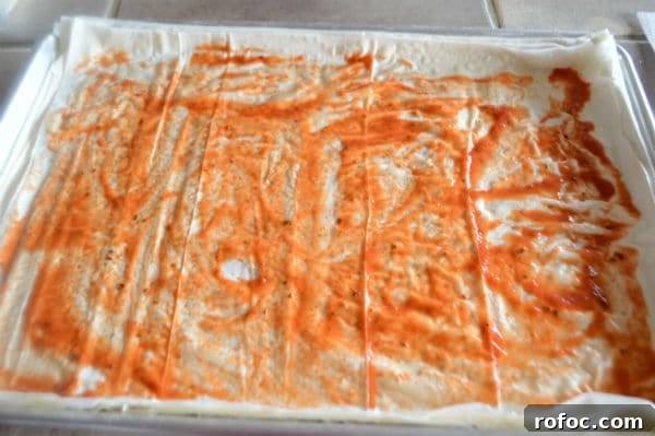 Game-Day Shrimp Phyllo Pizza Bites: Crispy Appetizer Recipe 6 A photo showing sheets of pastry and sauce