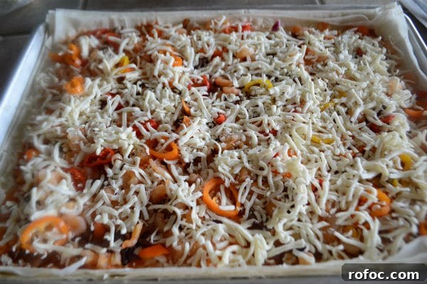 Game-Day Shrimp Phyllo Pizza Bites: Crispy Appetizer Recipe 7 A pan is filled with food, with Shrimp cheese and vegetables