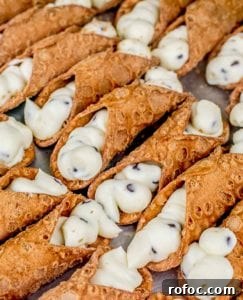 Classic Italian Cannoli Recipe: Crispy Shells & Sweet Ricotta Filling 4 Sheet pan of 2 dozen cannoli filled with sweet ricotta filling and chocolate chips