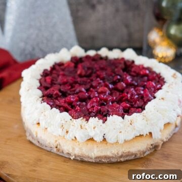 Low-Carb Cranberry Cheesecake: Keto Holiday Dessert Recipe 13 A cranberry cheesecake on a wooden cutting board.