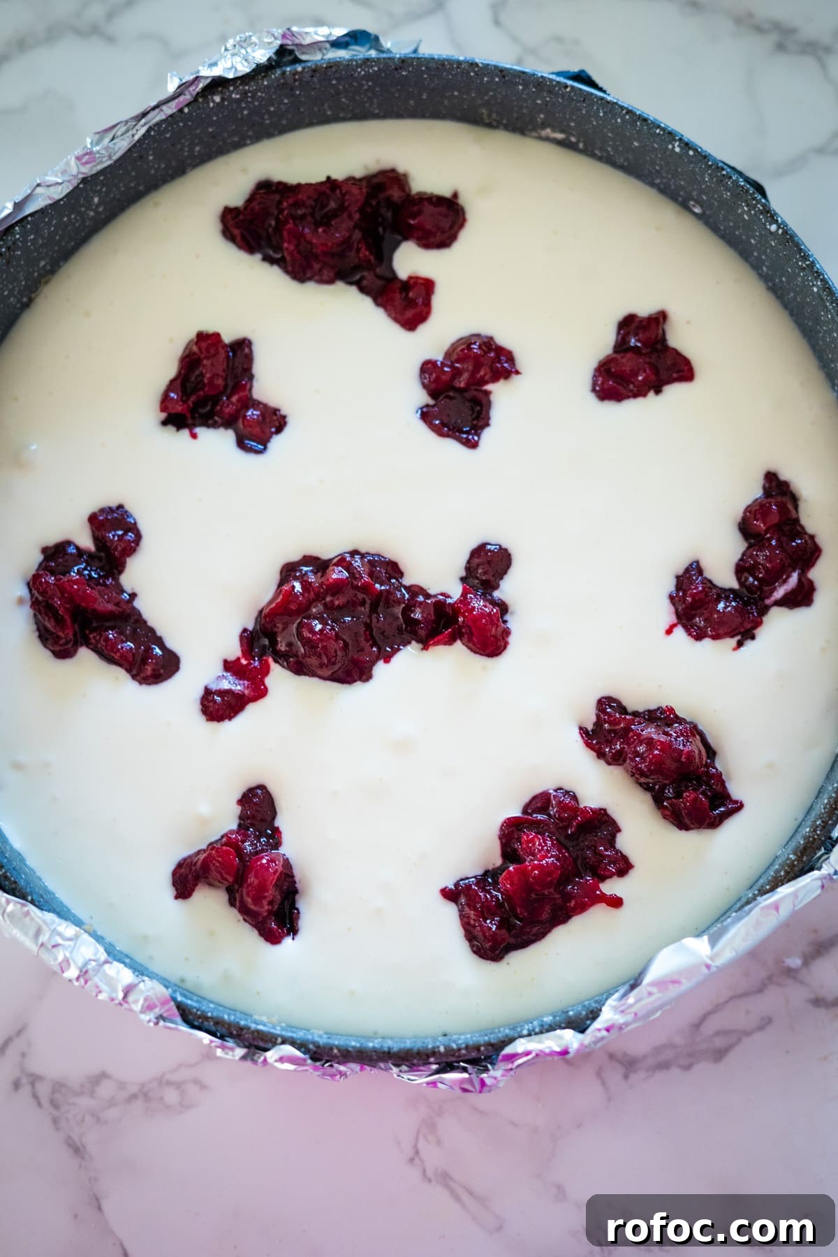 Low-Carb Cranberry Cheesecake: Keto Holiday Dessert Recipe 8 A white pie with cranberries on top, reminiscent of a cranberry cheesecake.