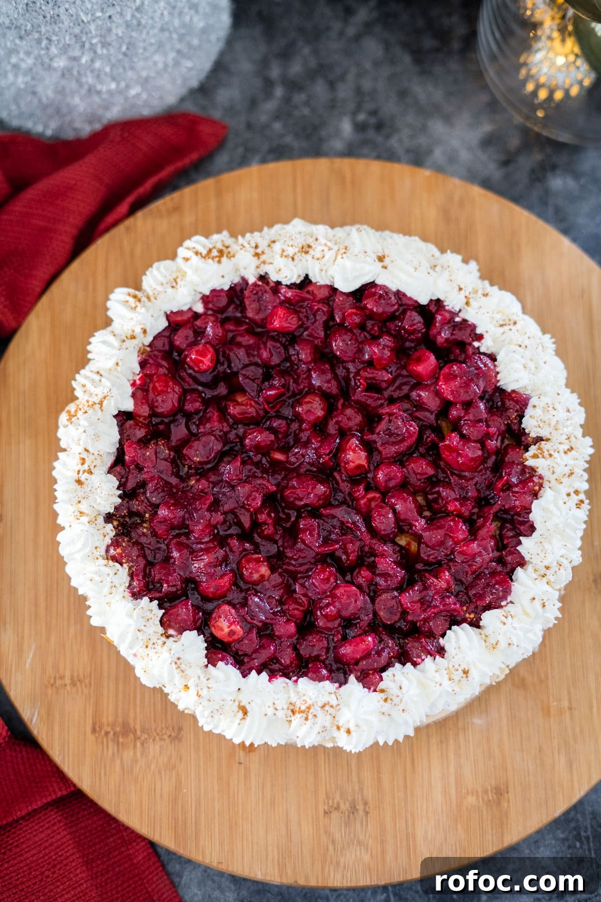 Low-Carb Cranberry Cheesecake: Keto Holiday Dessert Recipe 10 A cranberry cheesecake on a wooden cutting board.