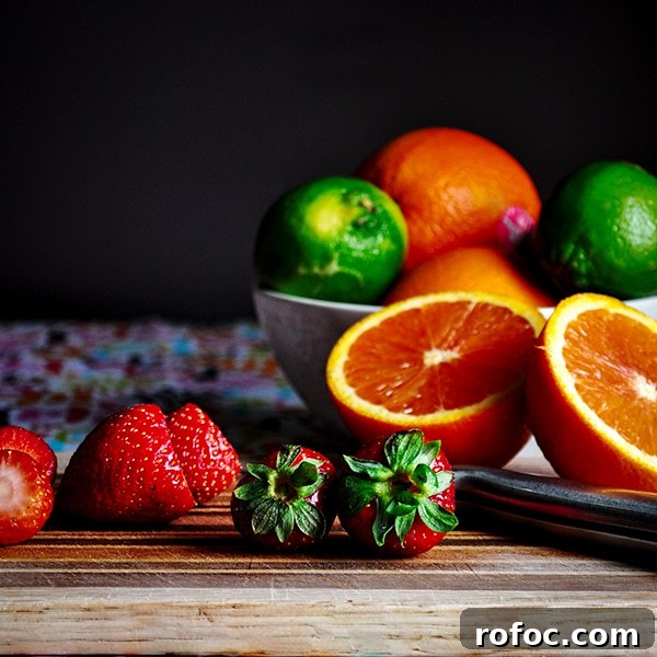 Strawberry Frozen Yogurt with Orange and Lime Zest 3 Fresh fruit being prepared to make healthy strawberry frozen yogurt.