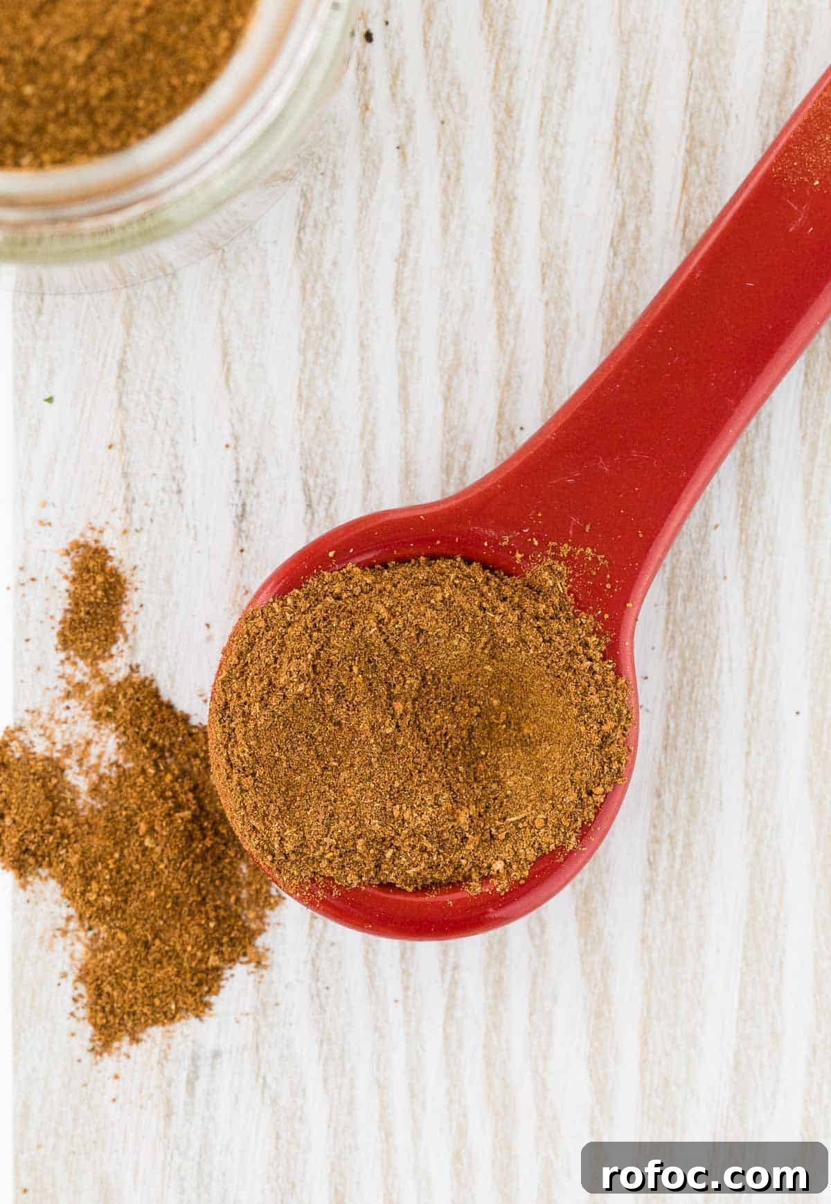 Homemade Apple Pie Spice Mix You Can Make in Minutes 6 Close up of spices on a red measuring spoon.
