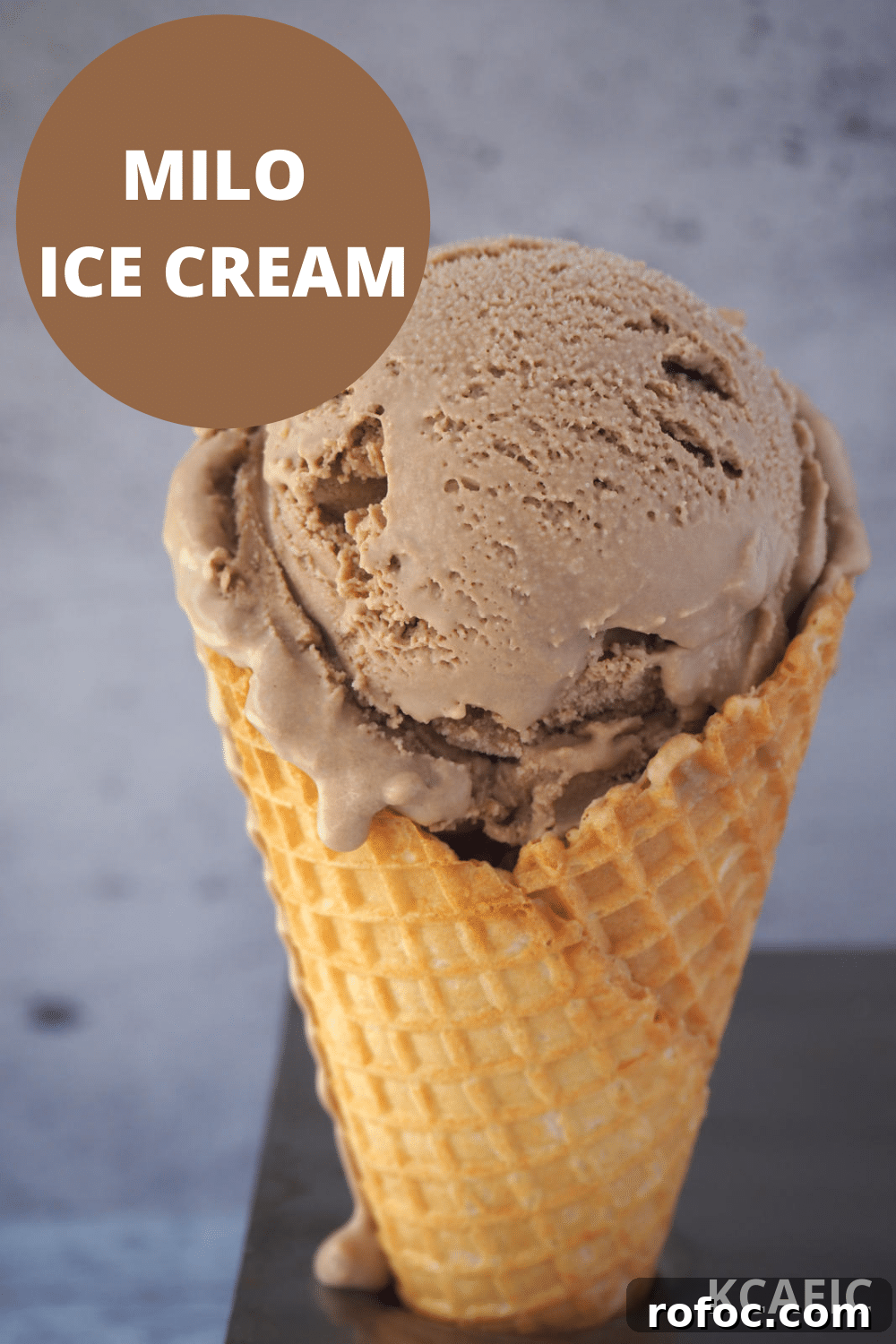 Creamy Milo Ice Cream Recipe: Homemade Milo Frozen Treat 14 Scoop of slightly melting Milo ice cream in an ice cream waffle cone, with text over lay, Milo ice cream and KCAEIC.