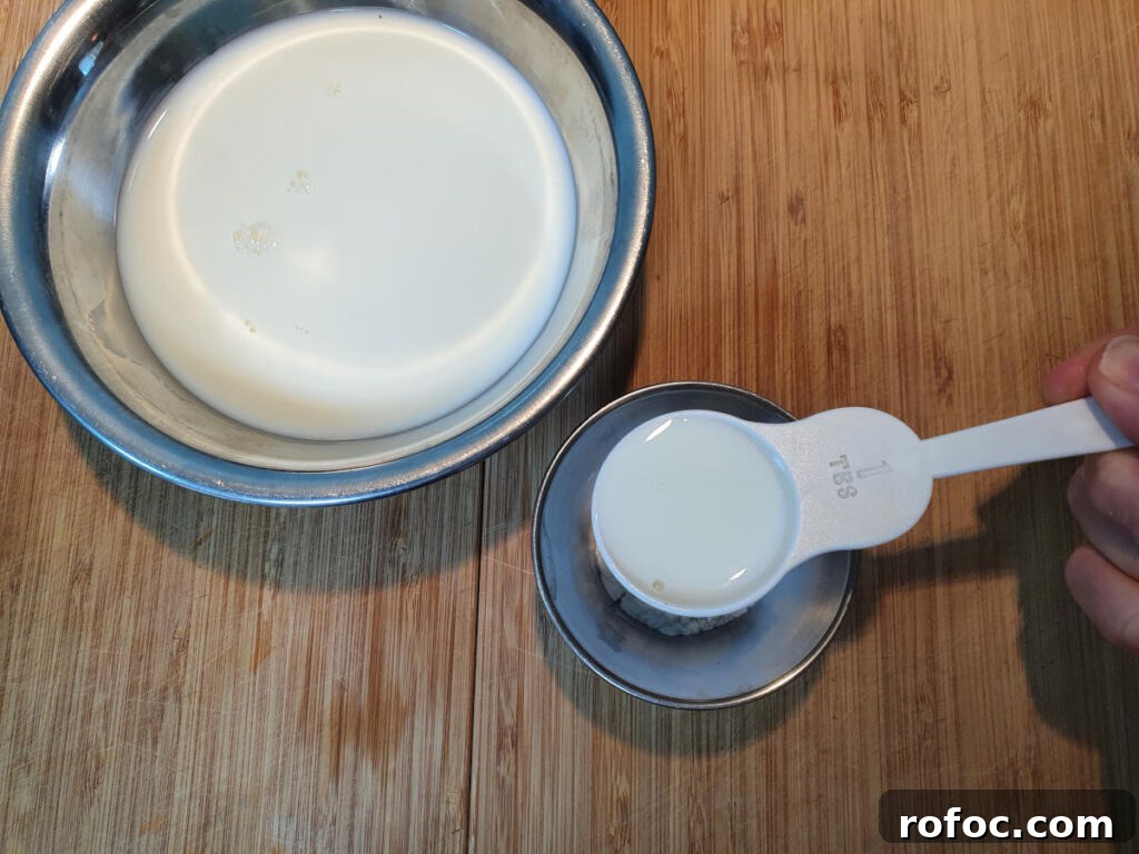 Creamy Milo Ice Cream Recipe: Homemade Milo Frozen Treat 6 adding milk to tapioca starch in small bowl to make a slurry.