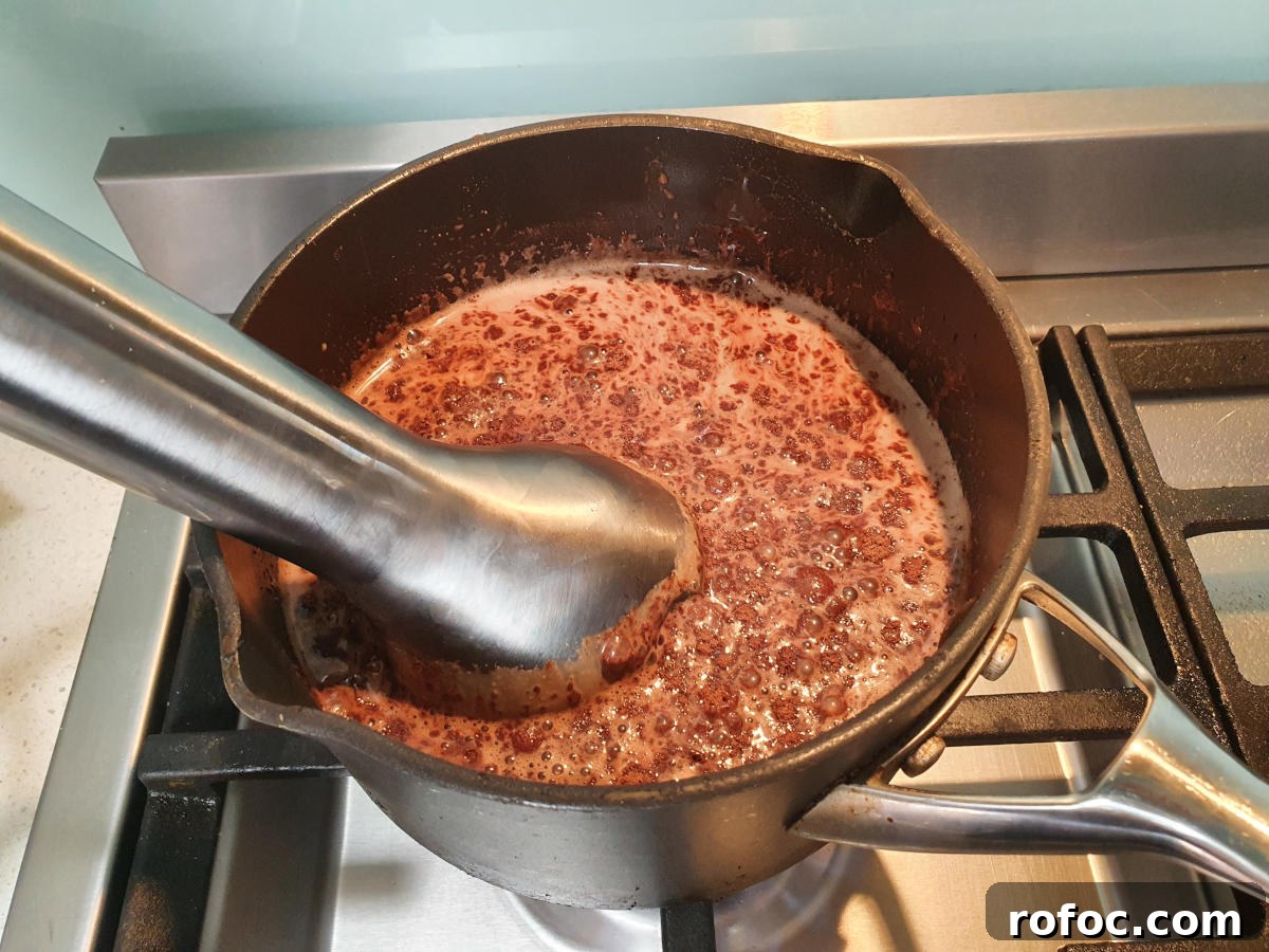 Creamy Milo Ice Cream Recipe: Homemade Milo Frozen Treat 7 blending ice cream mix with an immersion blender.