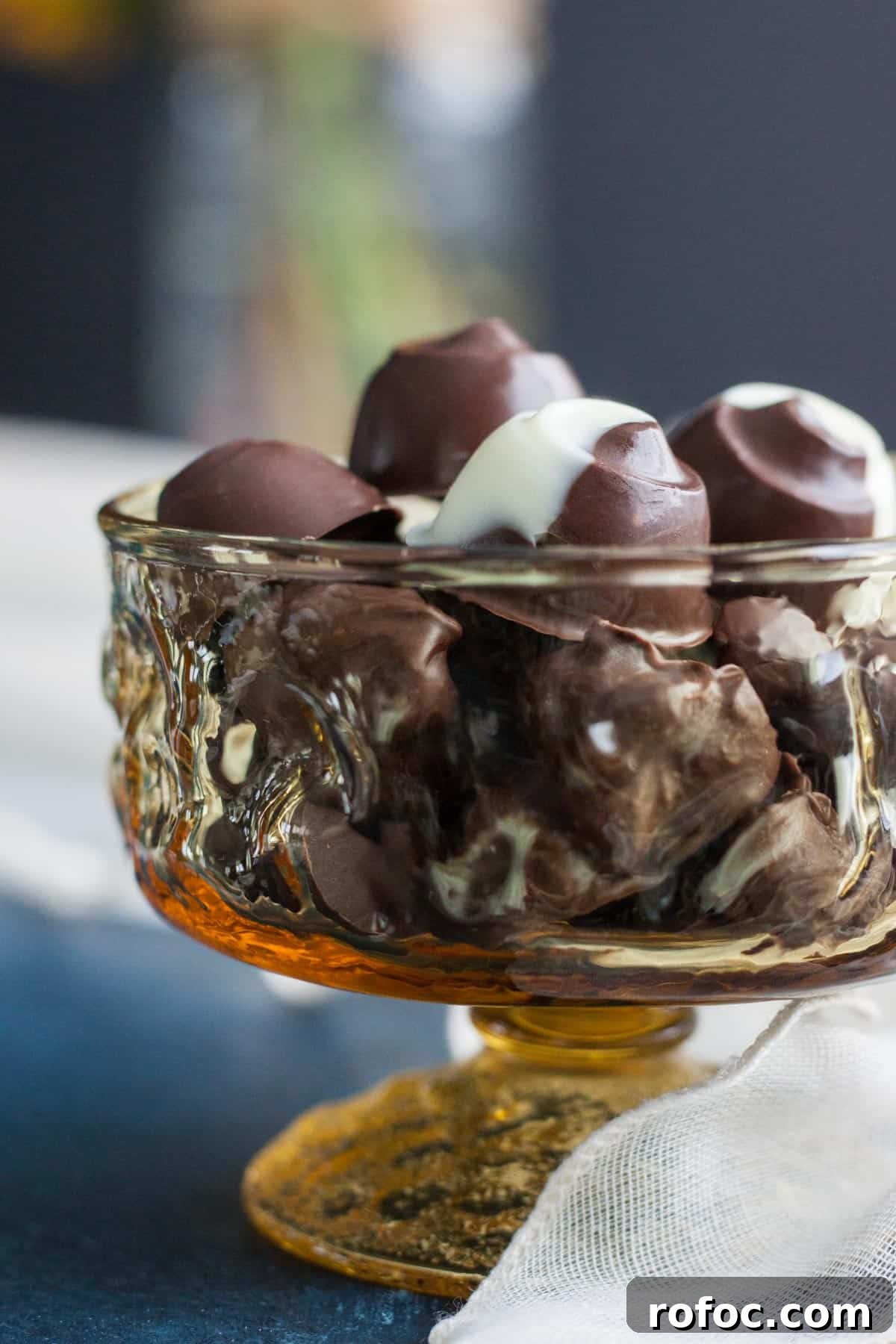 Viewing a bowl of Chocolate Covered Macadamia Nuts from the side.