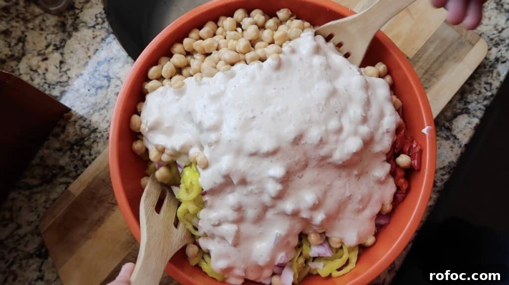 La Scala Pasta Salad Recipe: Classic Italian-Inspired Dish 12 Adding creamy Italian salad dressing to the bowl of pasta.