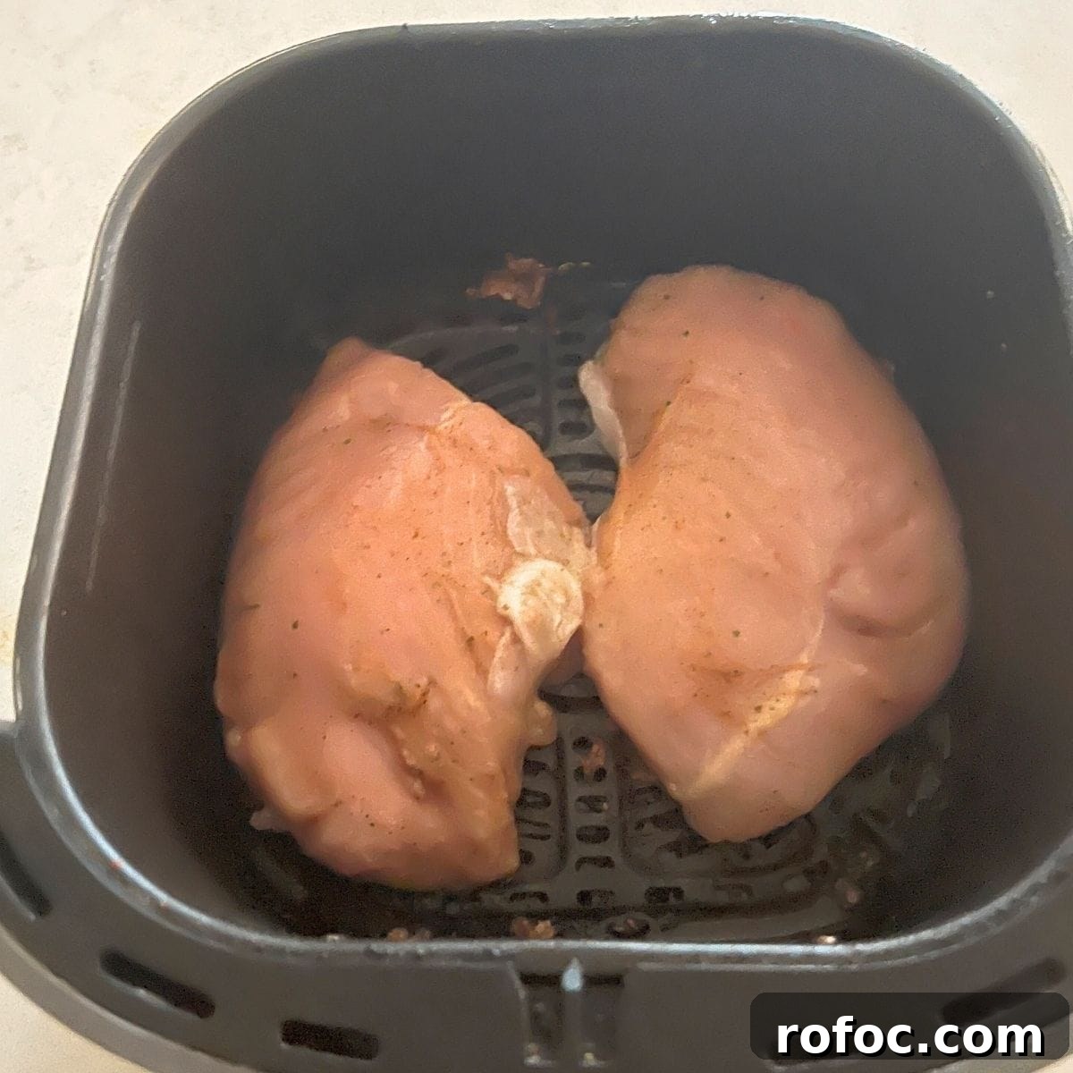 Crispy Air Fryer Turkey Tenderloin Recipe for Juicy Results 4 Turkey breast tenderloin in air fryer basket.