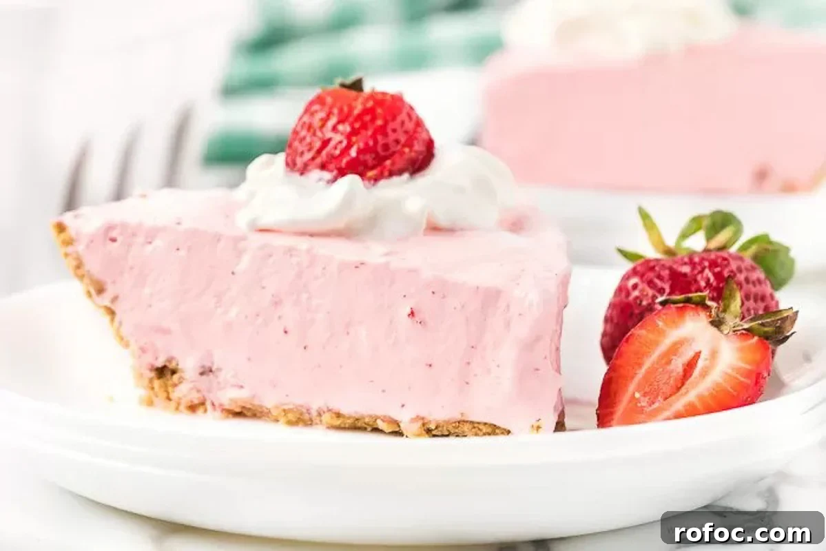 Strawberry Jello Pie: Quick No-Bake Summer Dessert Recipe 5 Strawberry Jello pie with a side of slice strawberries on a white plate