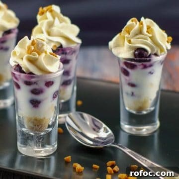 10 Delicious Saskatoon Berry Recipes You’ll Want to Try 8 saskatoon berry dessert shooters on a black tray with a spoon