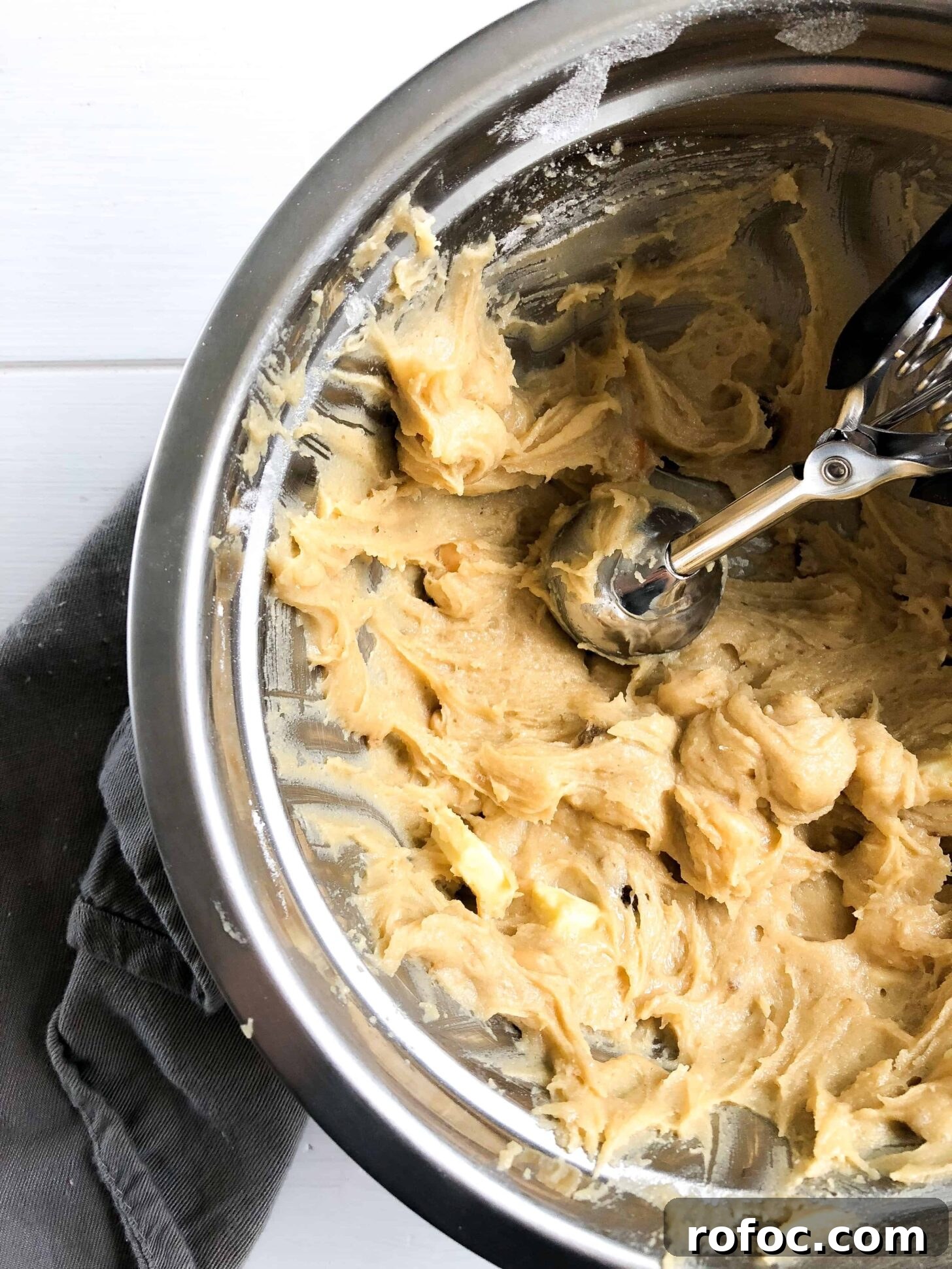 Gluten-Free White Chocolate Macadamia Nut Cookies 3 a bowl full of cookie dough and a cookie scooper