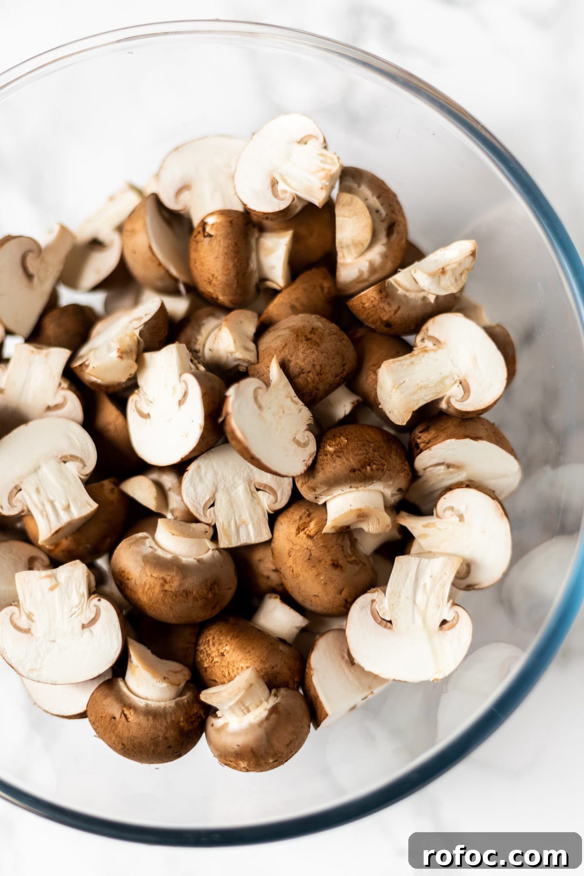 Creamy Mushroom Stroganoff Recipe for Weeknight Dinners 3 Sliced cremini mushrooms in a bowl.