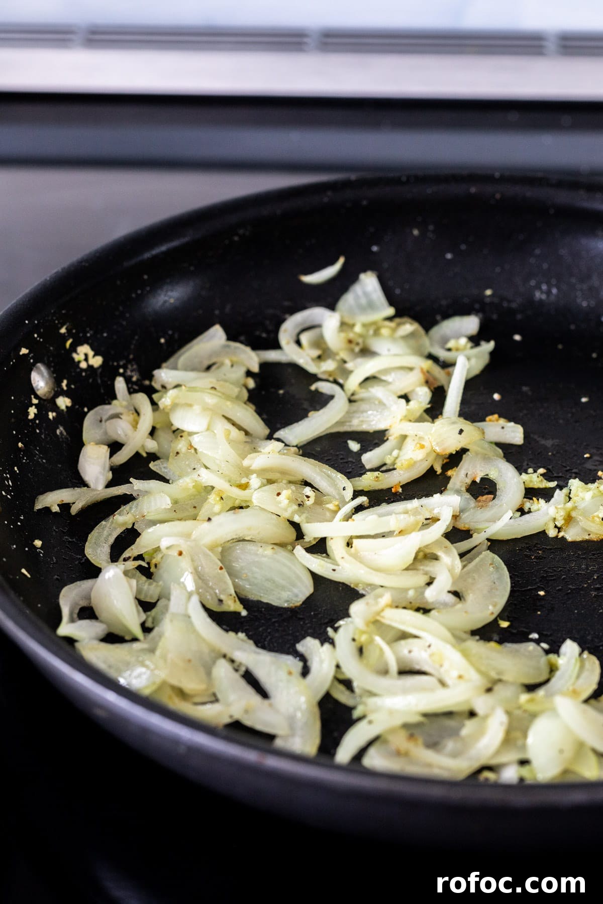 Creamy Mushroom Stroganoff Recipe for Weeknight Dinners 5 Sauteeing onions and garlic in a skillet.
