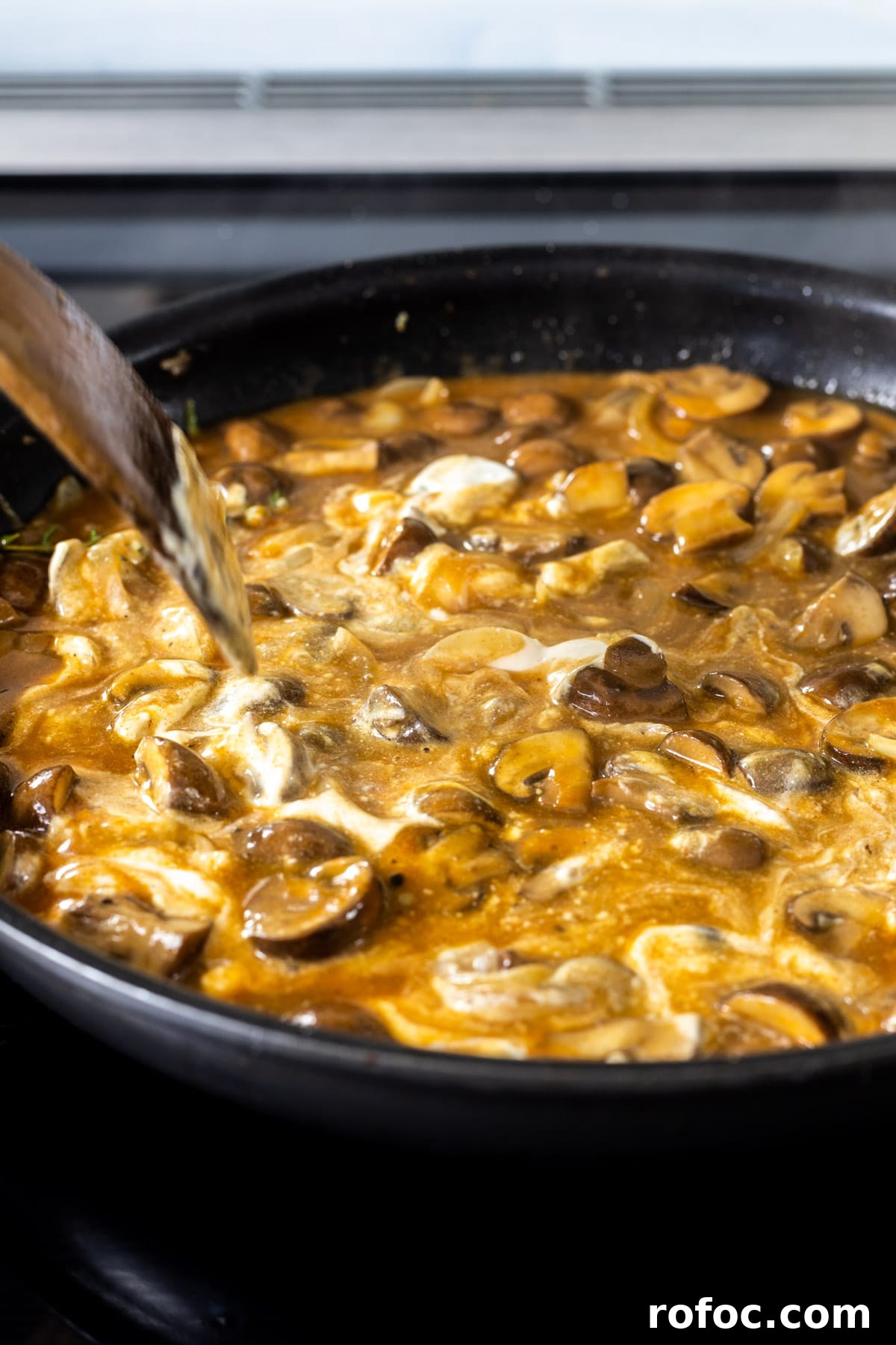 Creamy Mushroom Stroganoff Recipe for Weeknight Dinners 9 Stirring sour cream into stroganoff sauce.