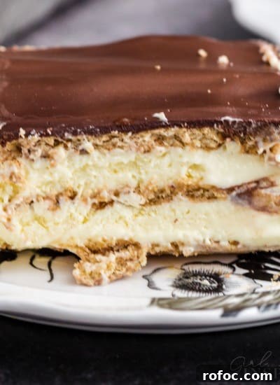 Slice of no bake eclair cake on a serving plate.