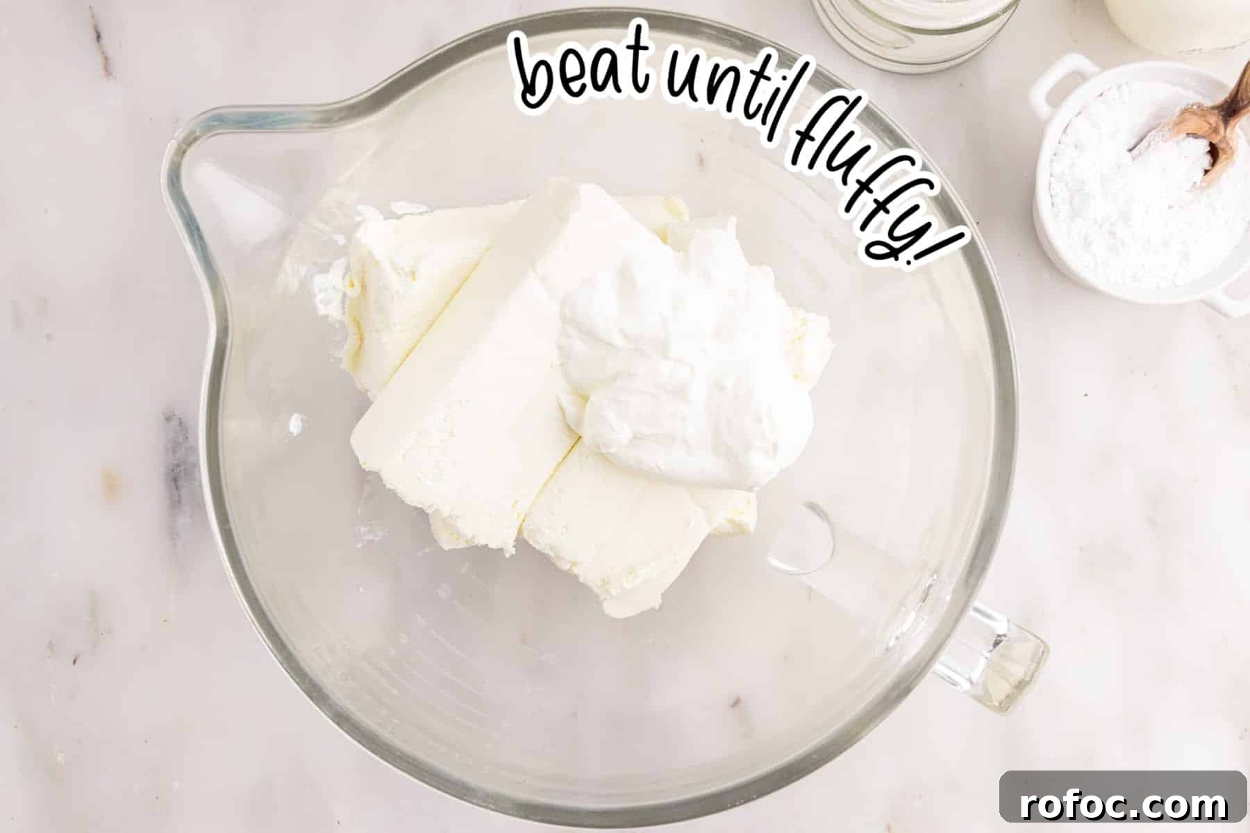Cream cheese and sour cream in a bowl.